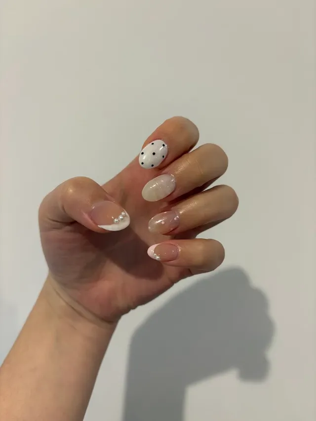 Milky French nails with black polka dots and pearls